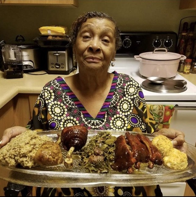 Aunt Connie holding a platter of food in her kitchen