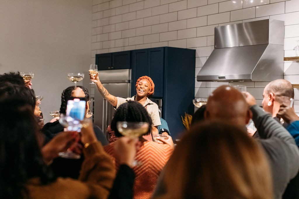 Mariya raising a toast with guests